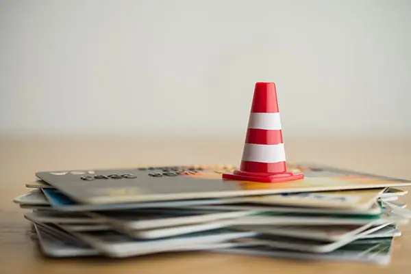 Traffic cone on top of a pile of credit cards