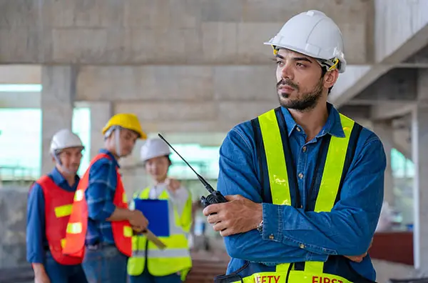 Sad construction worker is gossiped about and bullied