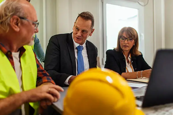 Construction worker meets with bosses