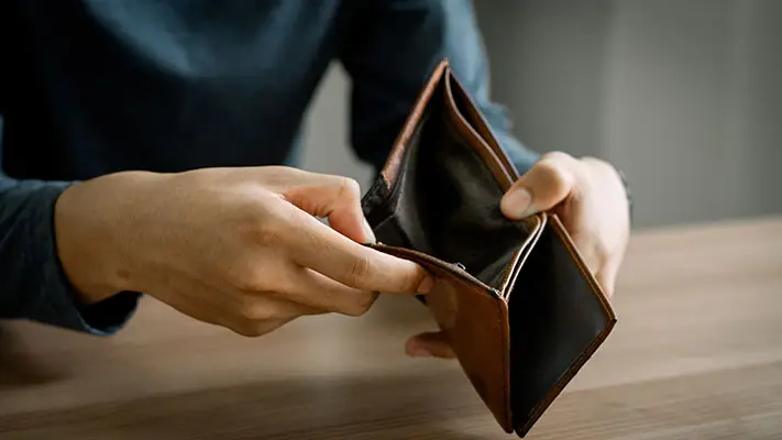 Someone holding open an empty wallet