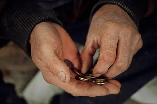 Old hands counting coins
