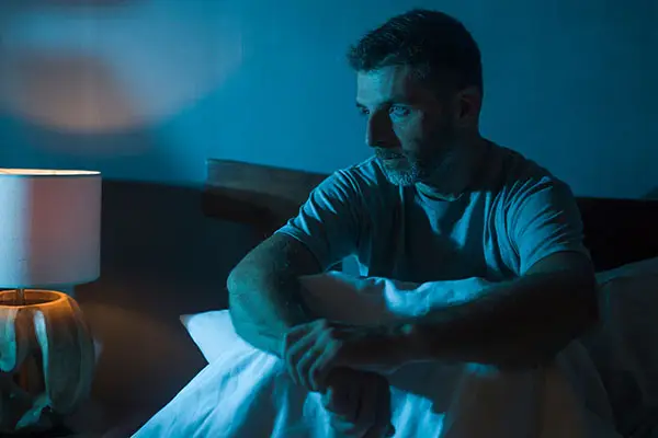 Man can't sleep, sits up in bed
