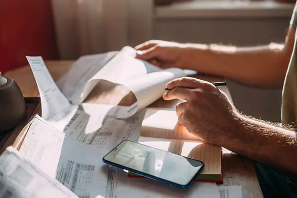 Man's hands with bills and calculator