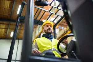 Man in a hard hat in a forklift