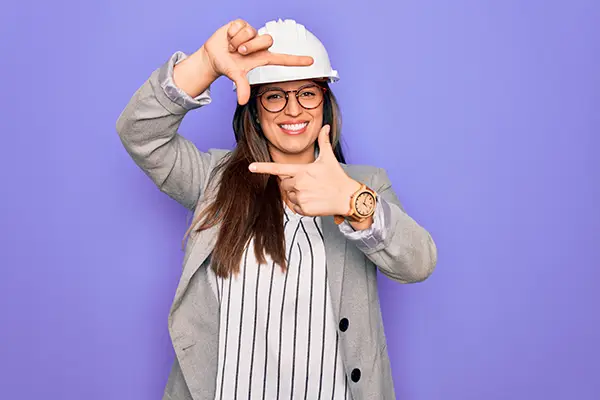 Woman in hardhat framing her face
