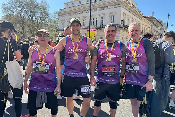 Four men in Lighthouse charity running vests