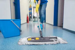 Cleaner mopping hallway