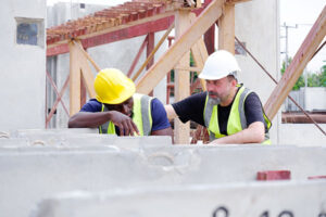 Two engineers look downtrodden at work