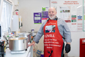 Adrian Boulter smiles next to a pot of curry