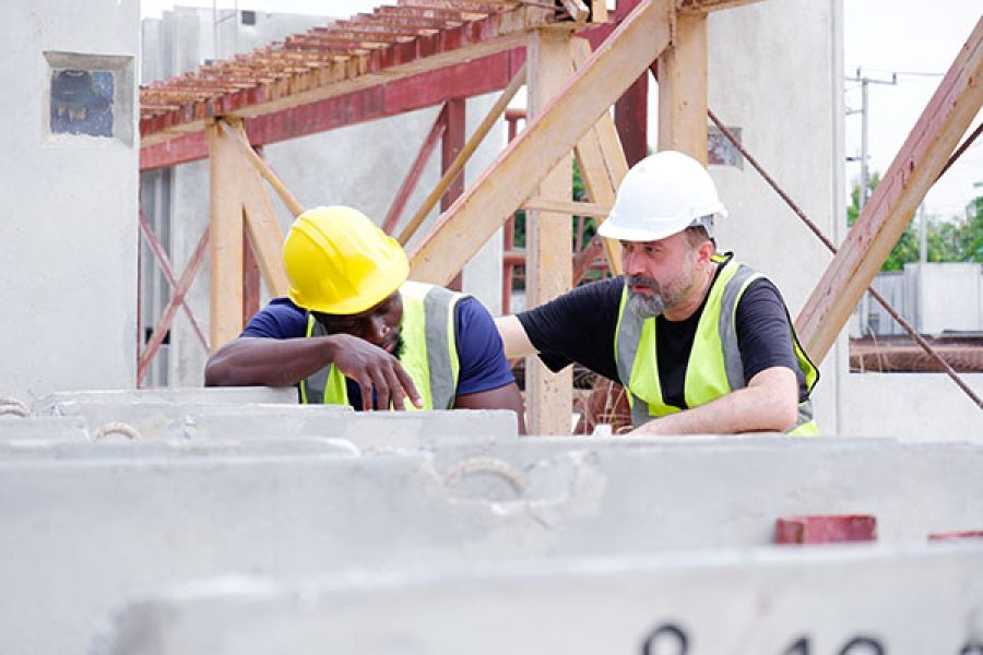 Two engineers look downtrodden at work
