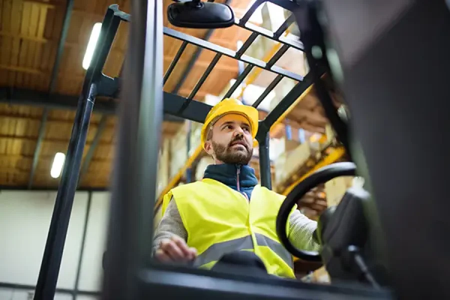 Man in a hard hat in a forklift
